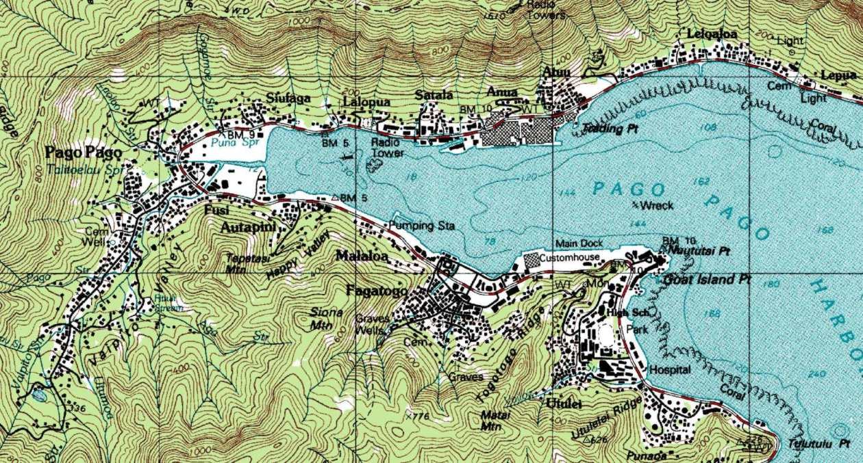 Pago Pago Harbor with sailboats and volcanic ridge