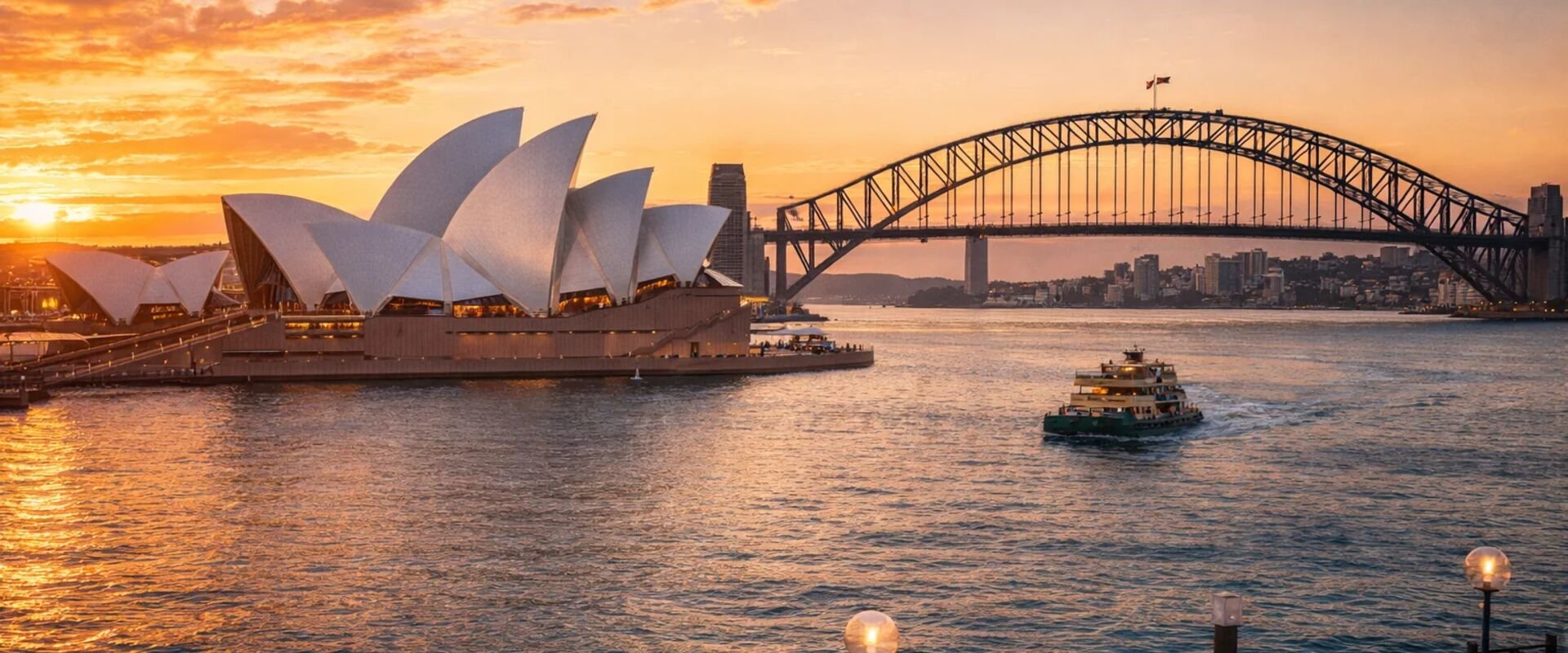 Sydney Opera House and Harbour Bridge seen across the water at dusk