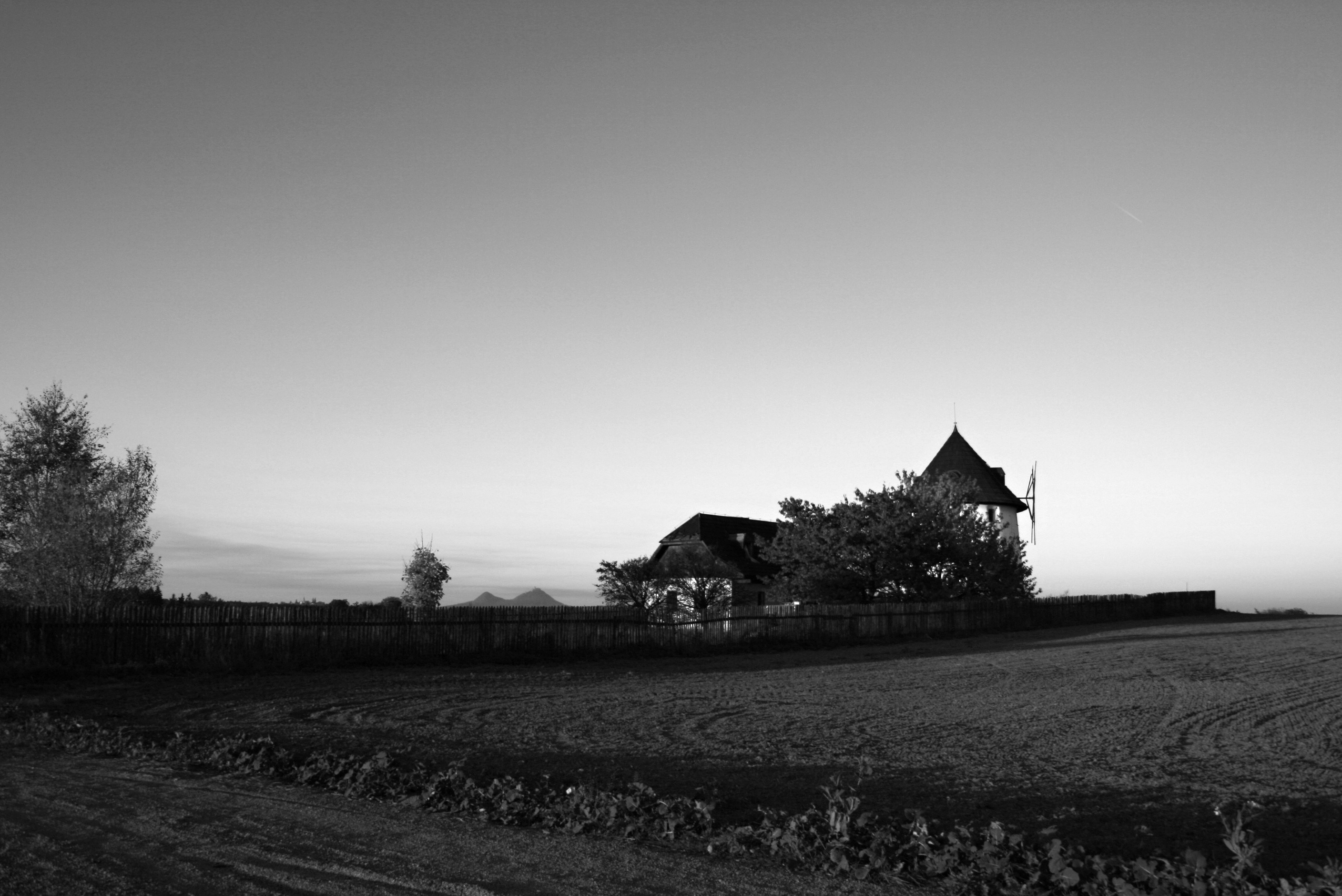 Vratno windmill silhouetted at dusk in a field