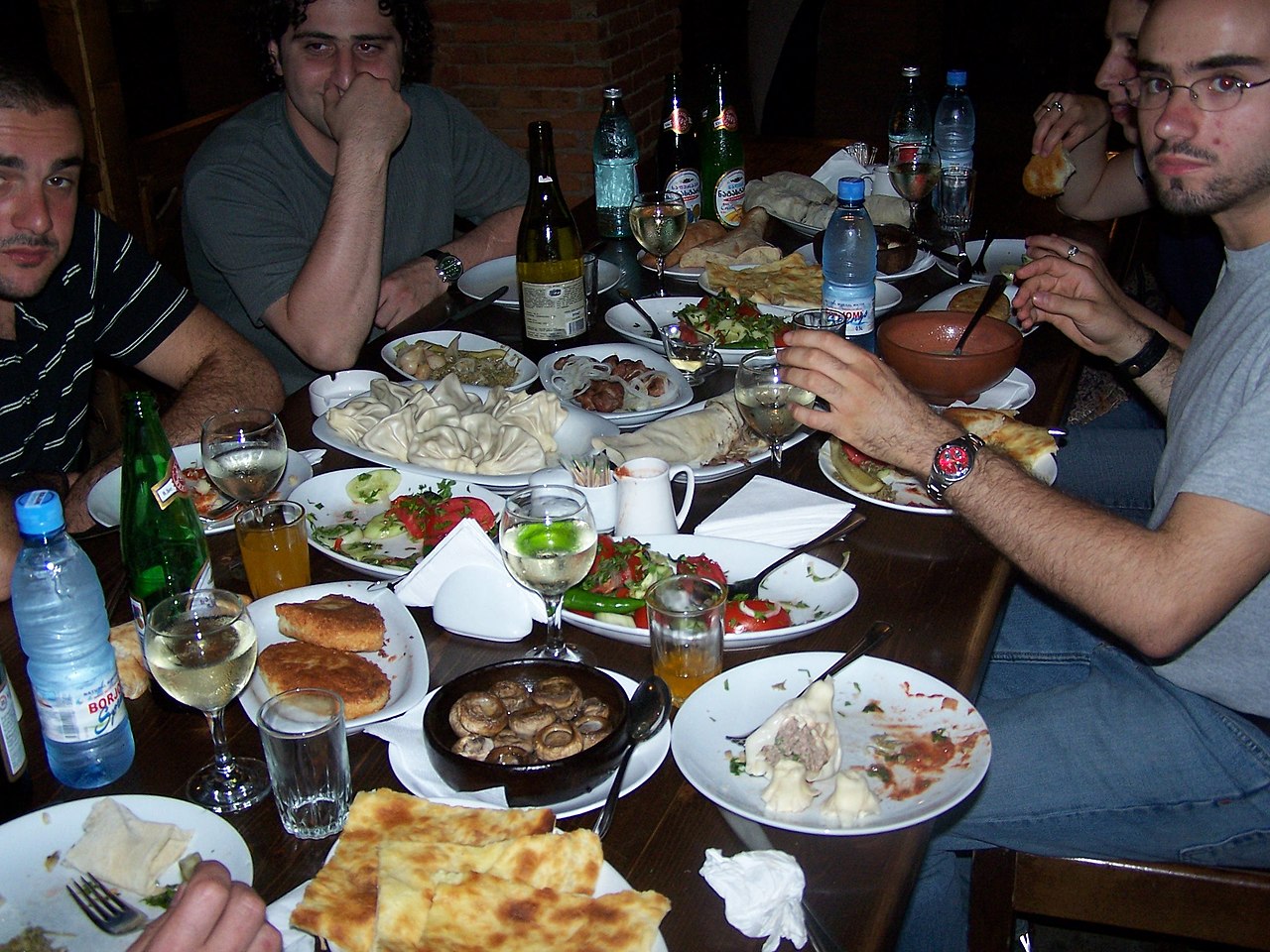 Traditional Georgian supra feast with khachapuri, khinkali and wine