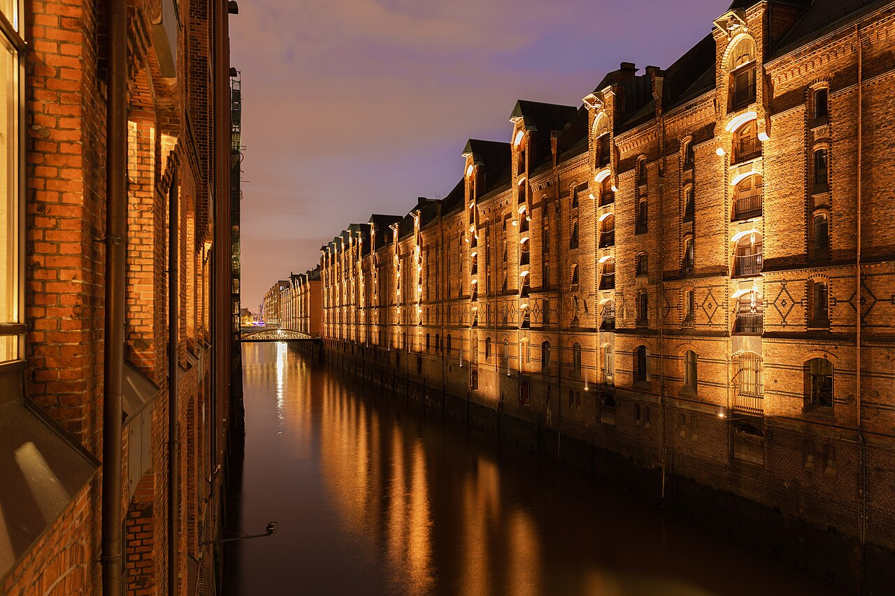 Speicherstadt warehouse district reflected in Hamburg canals at night