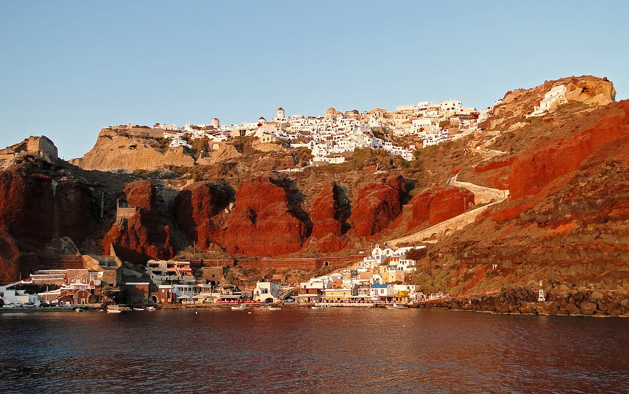 Santorini Oia village with iconic blue domed churches and white buildings