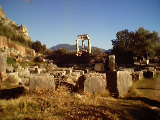 Temple of Apollo ruins at Delphi with mountain backdrop