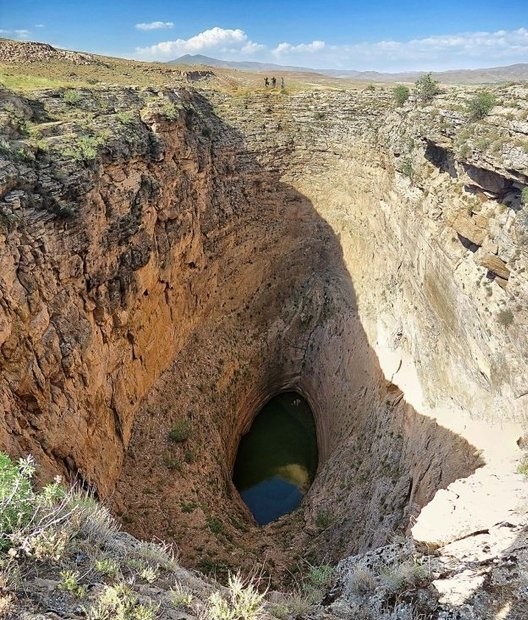 Zendan-e Berenjeh, a deep travertine sinkhole with a lake at the bottom, West Azerbaijan, Iran