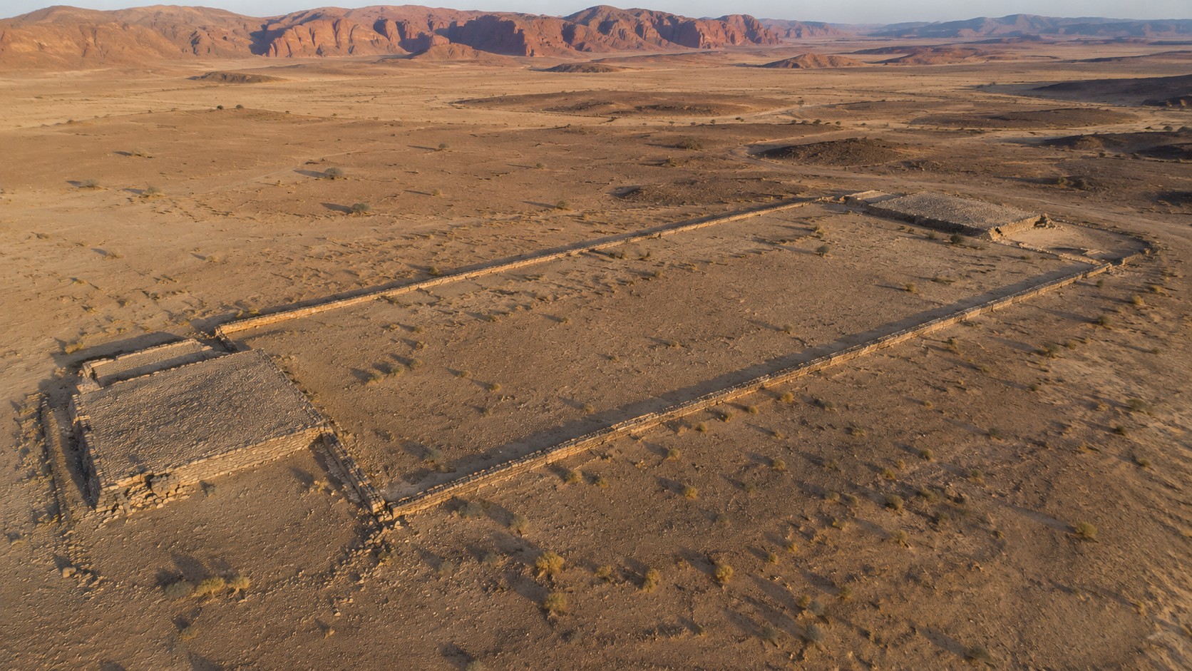 A mustatil, an ancient rectangular stone structure visible from above in the Saudi Arabian desert